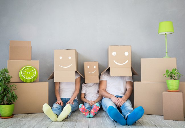 Happy family playing into new home.